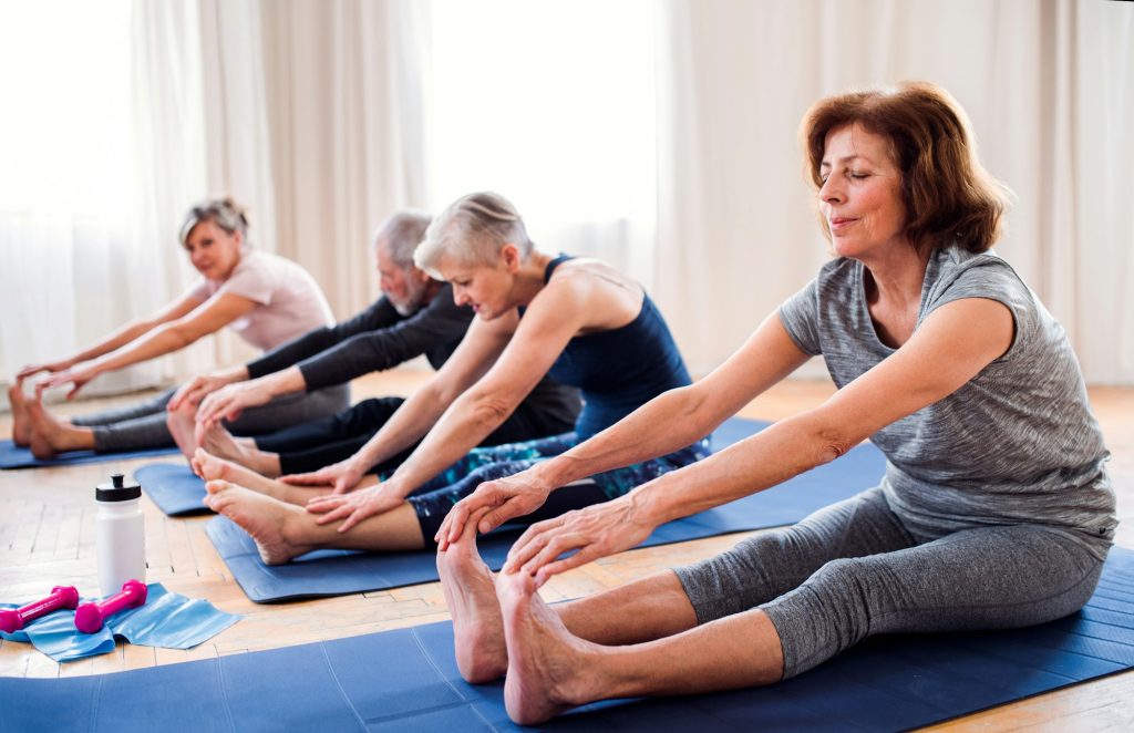Group of senior people doing exercise in community center club